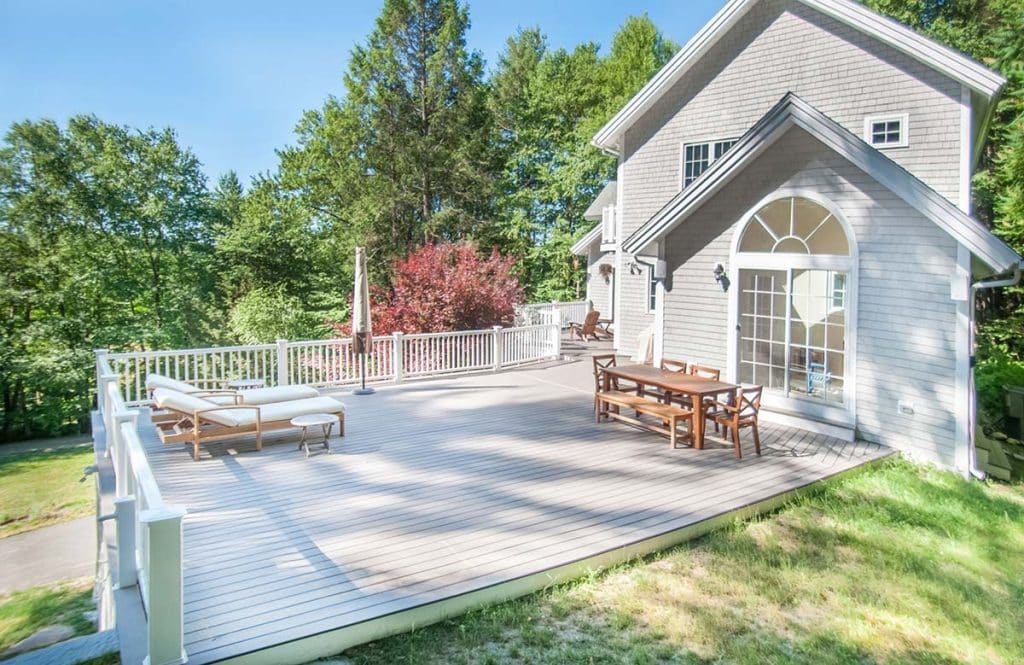 Photograph of an energy-efficient sunroom and deck addition completed by Integrity Development & Construction in Leverett, MA.