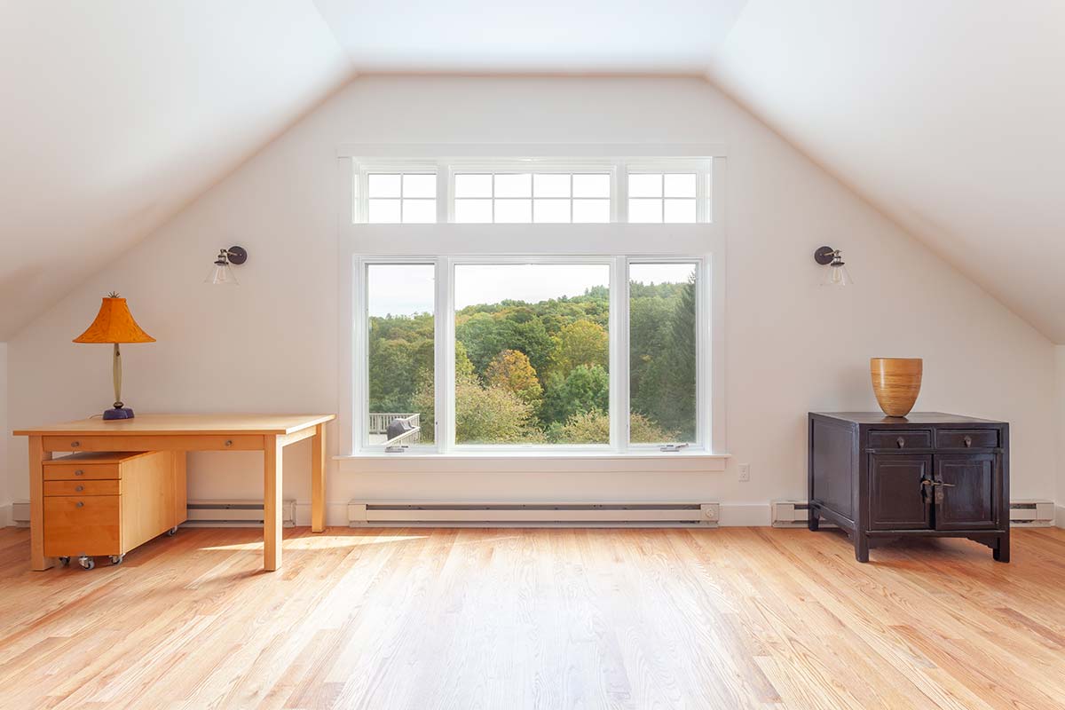 Photograph of a post-and-beam home renovation including a garage and studio addition, mudroom addition, and kitchen and bathroom remodeling completed by Integrity Development & Construction in Conway, MA.