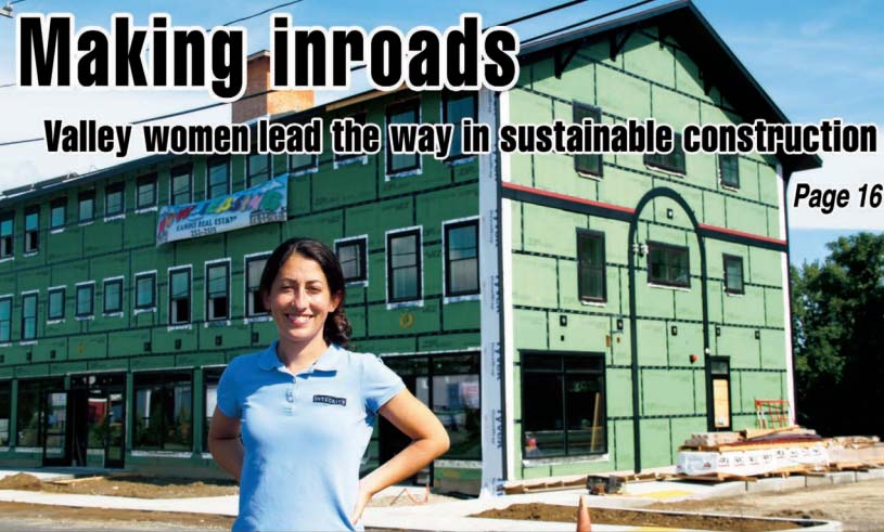 Anna Cook in front of the Trolly Barn in Amherst, MA, during construction.